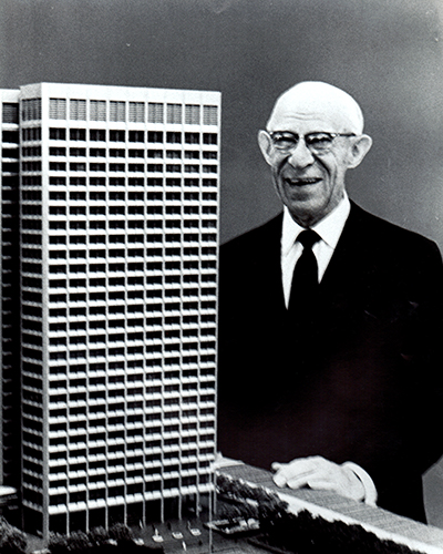Alonzo B. Ordway is seen here posing next to a scale model of the Ordway Building 