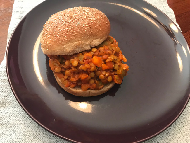 Sandwich bun containing a sloppy joe mixture made up of lentils and other vegetable ingredients