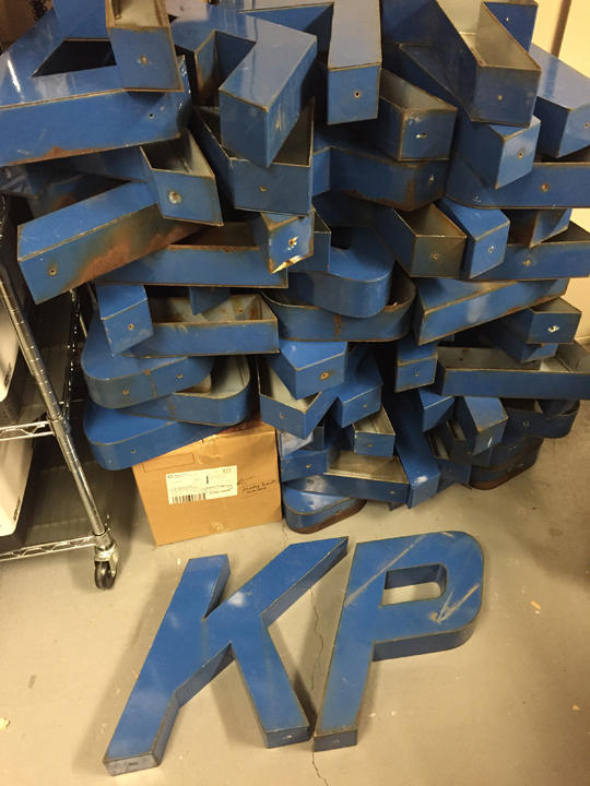 letters used in an old Kaiser Permanente sign now stacked in a pile in storage