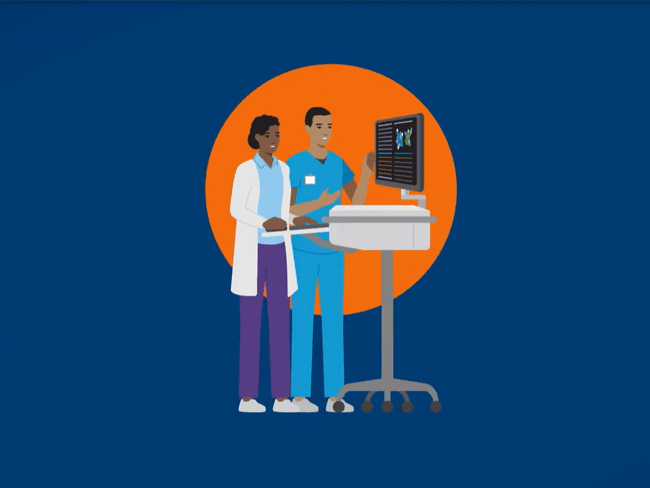 Doctor and nurse in discussion while looking at a monitor,.