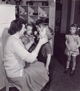 Children getting a medical checkup at Kaiser Oregonship child development center, circa 1944