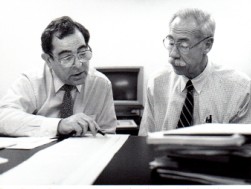 Leonard Rubin and Sam Sapin seated at table and reviewing medical charts