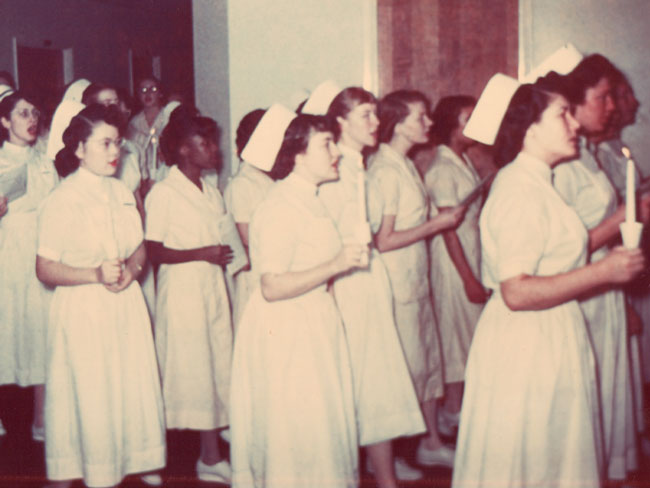 KFSN students in capping ceremony (after 6 months of study) walk through Kaiser Oakland hospital, circa 1960