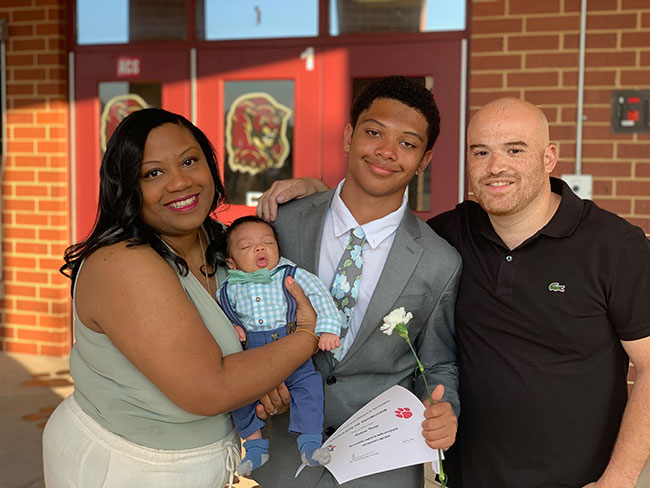 Anonye family smiling at sons graduation