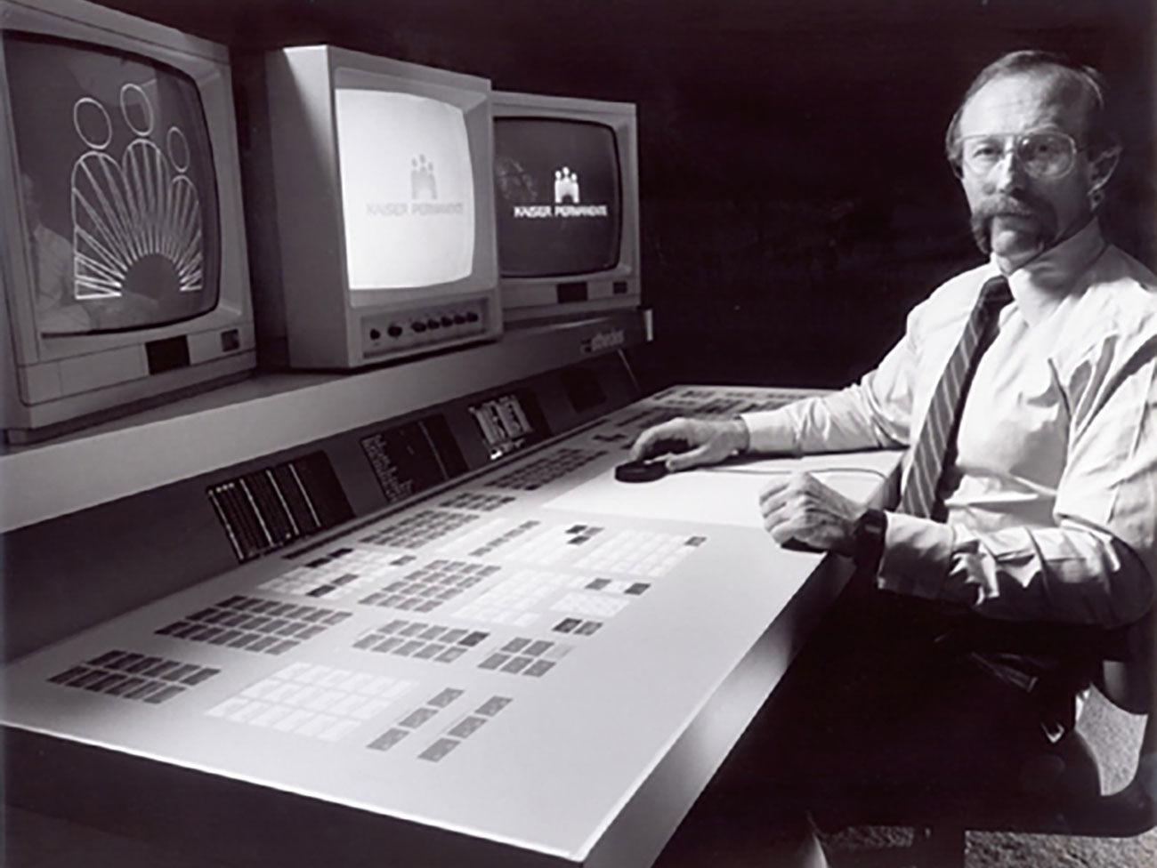 Douglas Boyd sitting at graphic design computers