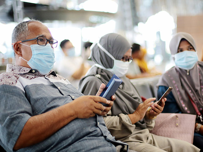 Muslim family wearing masks in airport