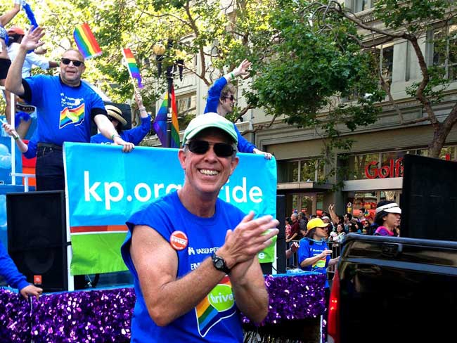 2013 San Francisco Pride march, with Jim Best (foreground) and Gregory A. Adams (Executive Vice President and Group President, on float); photo by Ces Rosales