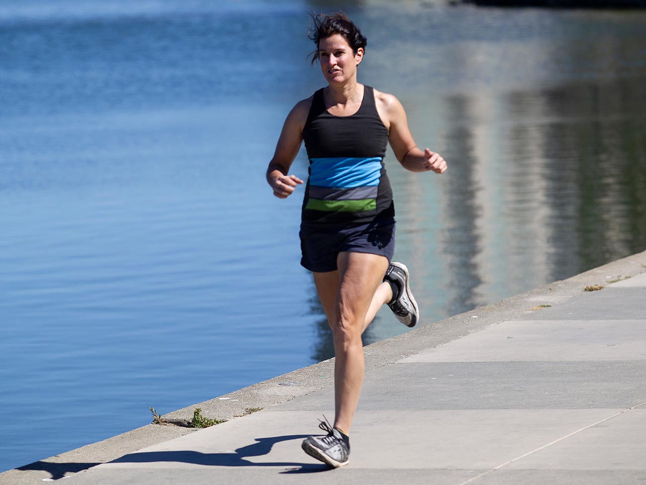 woman running next to lake