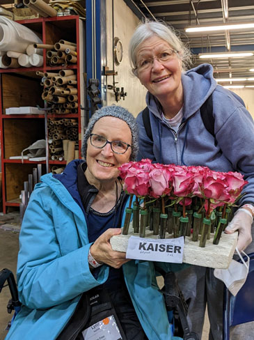 Lynn and her sister Gail are holding flowers