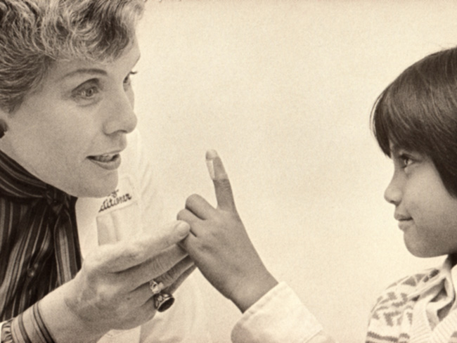nurse helping child with bandaged finger