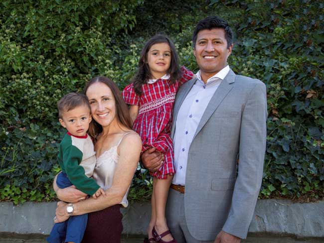 smiling parents with 2 young children outside