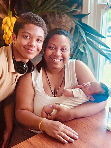 Tiffany Anonye holding baby and her son standing next to them