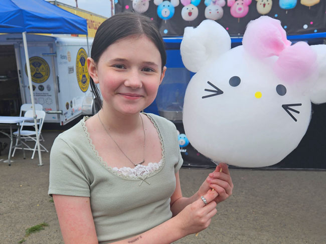 Zoe Berger smiling with Hello Kitty balloon