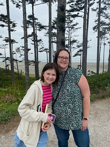 Zoe (left) and Jamie Berger enjoy a walk along the Oregon coastline.