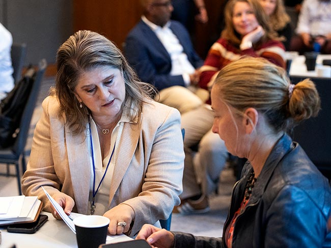 Two women in discussion during national Alliance national bargaining.