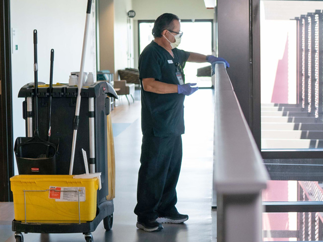 janitor sterilizing surfaces in a medical care facility