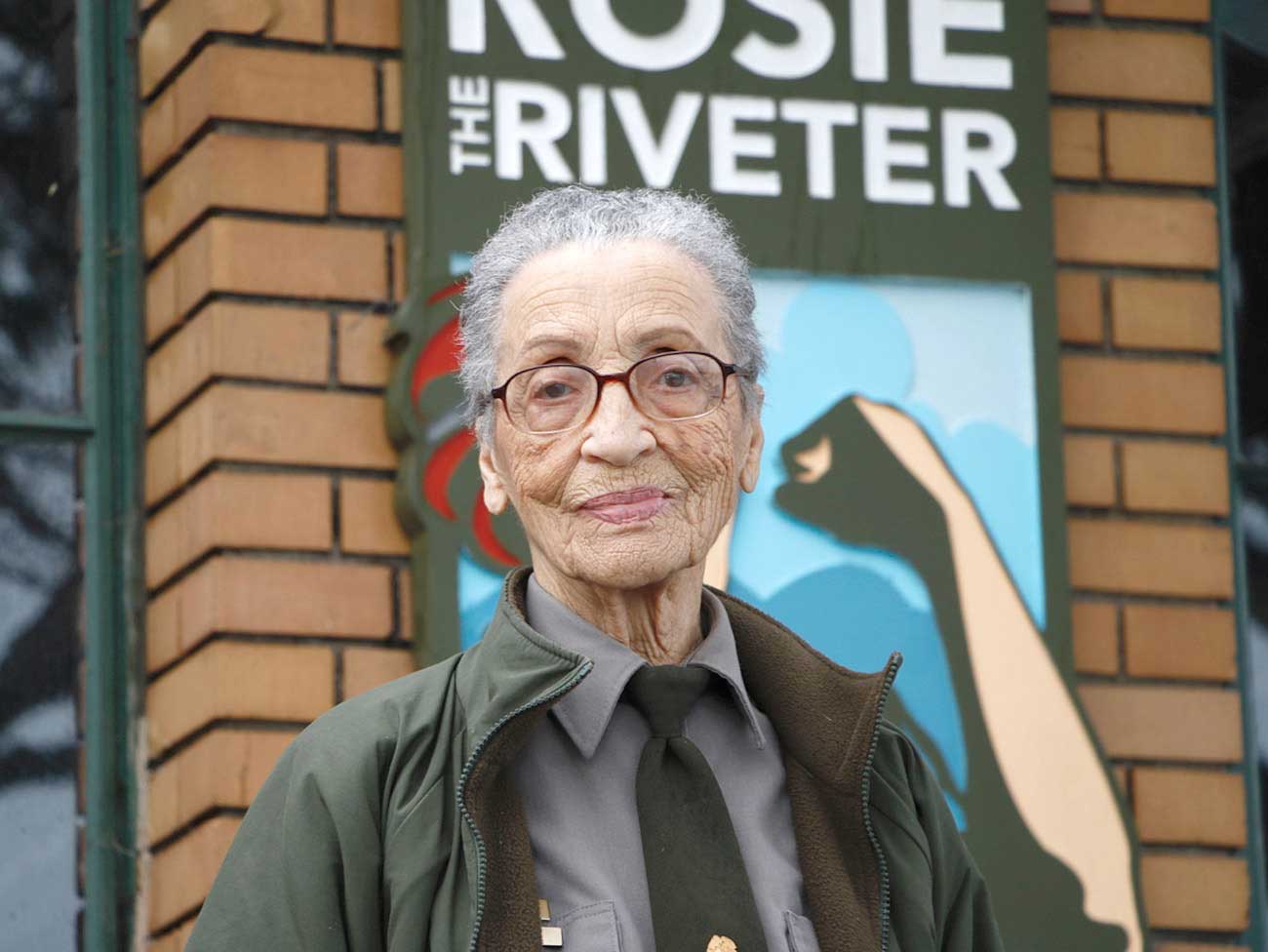 Betty Reid Soskin standing in front of the Rosie the Riveter Museum in Richmond, California.