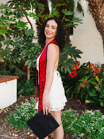 Camille in a graduation stole and cap