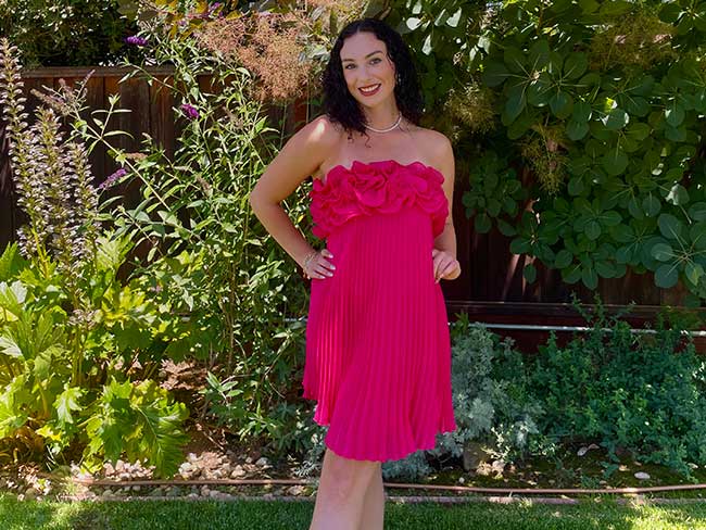 Camille Cline poses outside in a pink dress