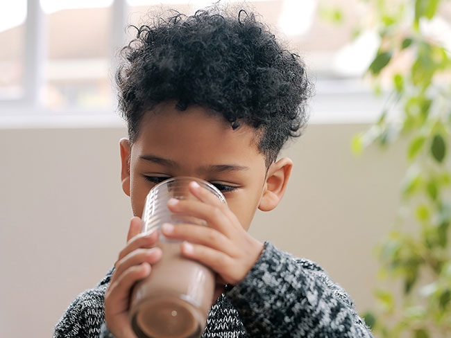 Child drinking chocolate milkshake