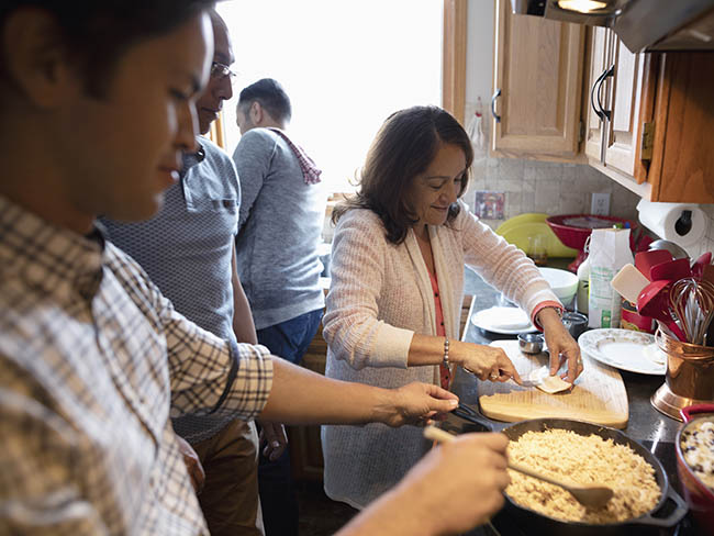 latino family in their kitchen preparing a meal