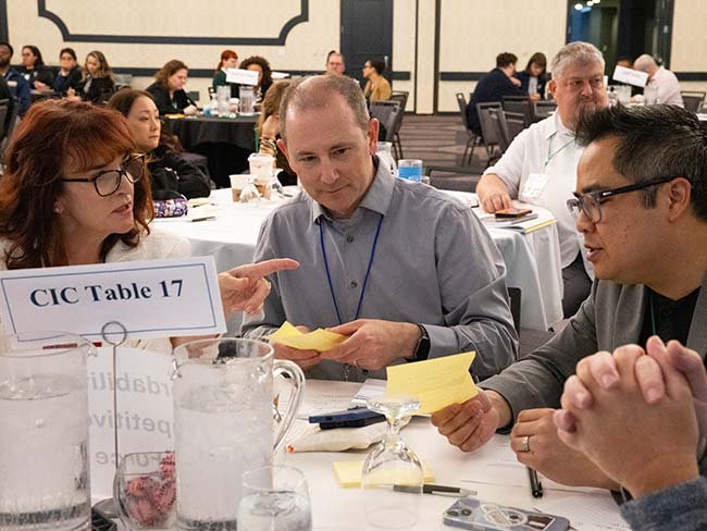 A group of colleagues sitting around a table in deep discussions.