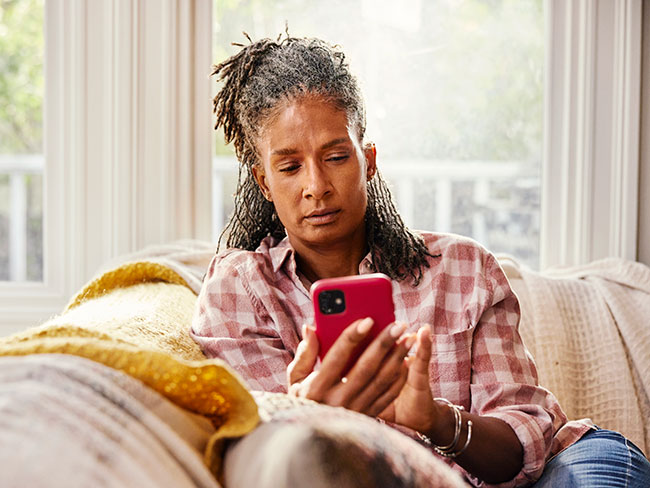 Concerned woman looking at her smart phone