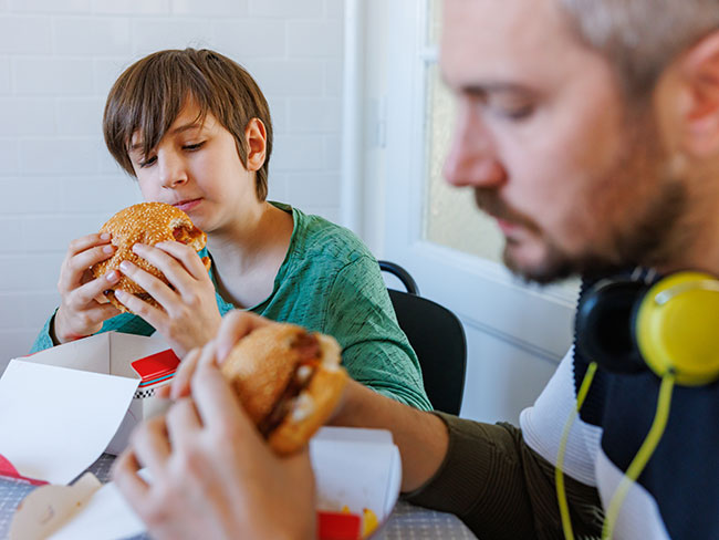 Dad and son eating together