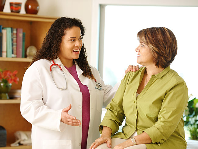 Female doctor putting a hand on patient's shoulder