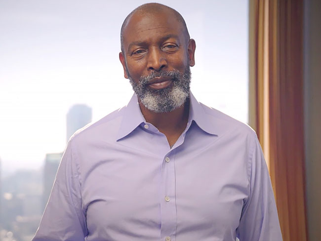 Greg Holmes in front of window