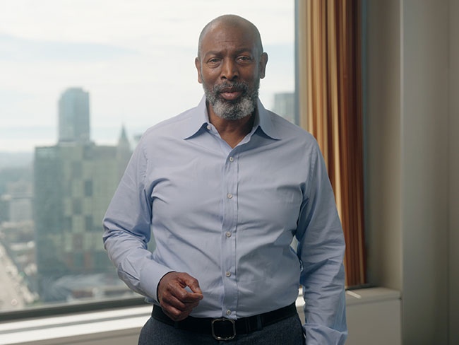 Greg Holmes standing by an office window