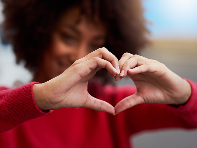 woman with hands in heart  shape