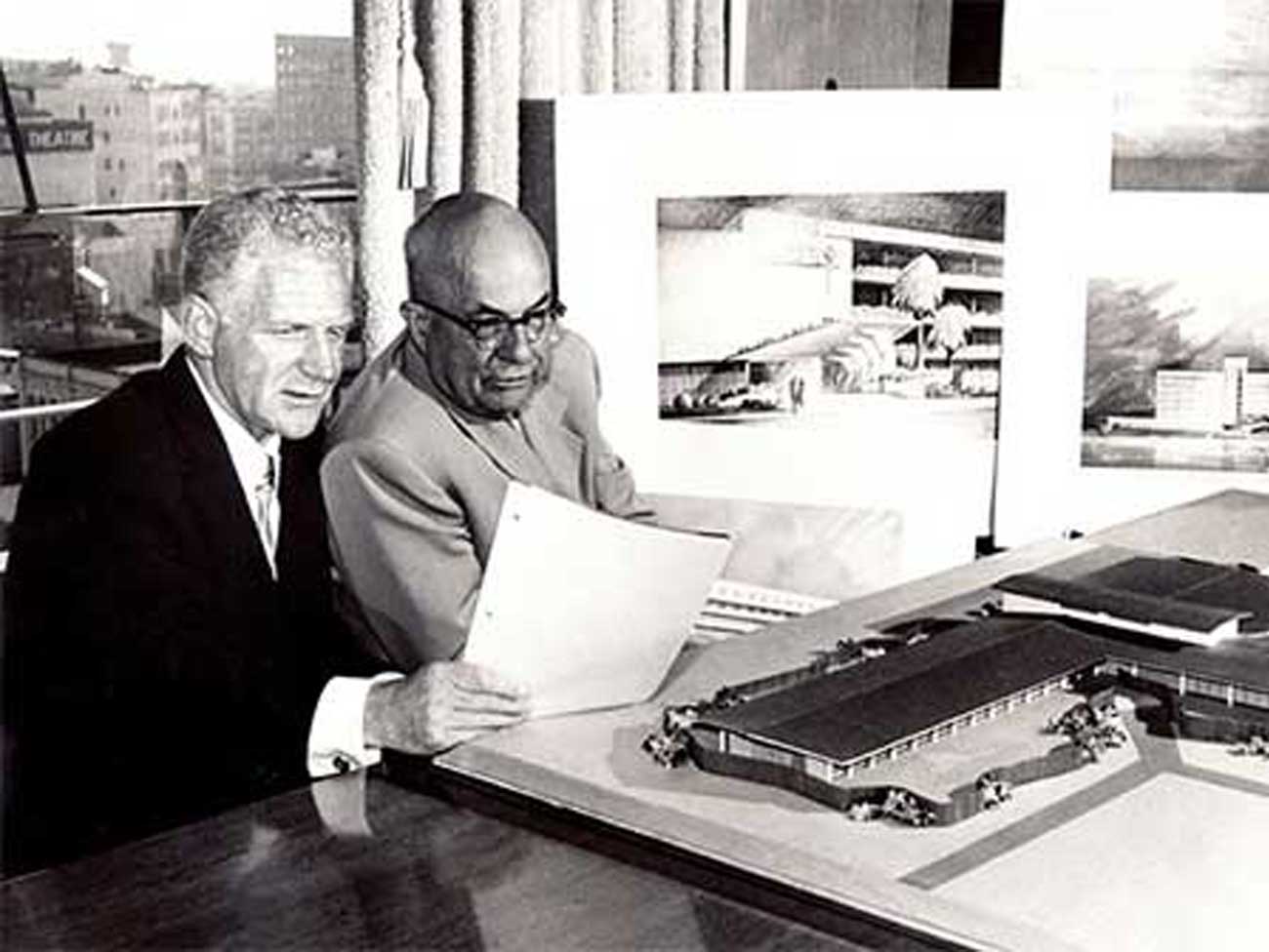 Sidney R. Garfield, MD, and Henry J. Kaiser review designs for 3 modern Kaiser Permanente hospitals for Walnut Creek, San Francisco, and Los Angeles in 1953. 