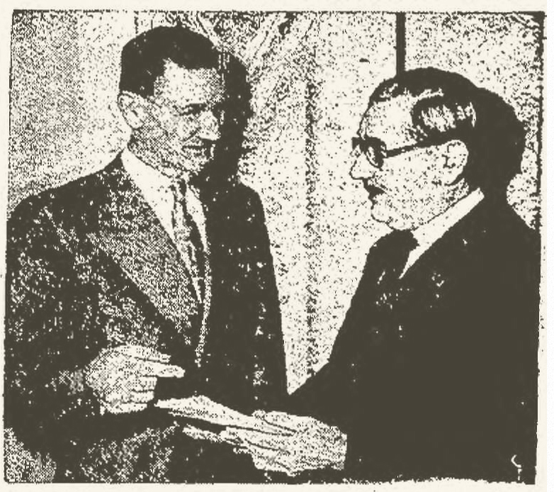 Carl Brown (left), president of the Independent Foremen's Association of America, confers with Harry F. Morton while representing Kaiser-Frazer. UPI newspaper photo, 2/19/1949.