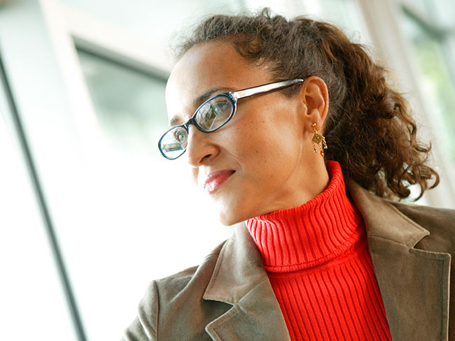 woman with glasses looking straight ahead