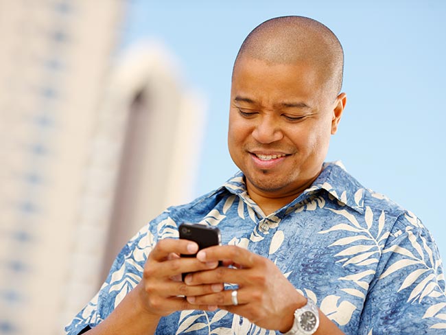 man concentrating on mobile phone