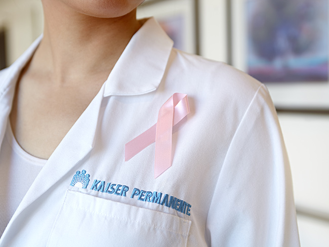 White coat with pink cancer ribbon attached