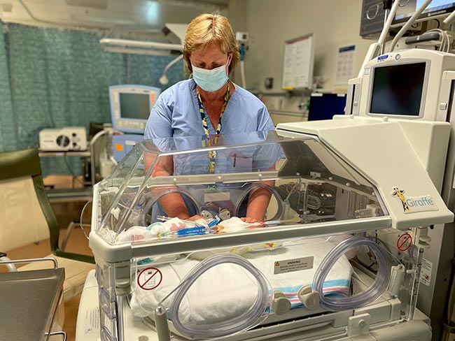 Linda Wynsma, RN, with a tiny patient in the neonatal intensive care unit.