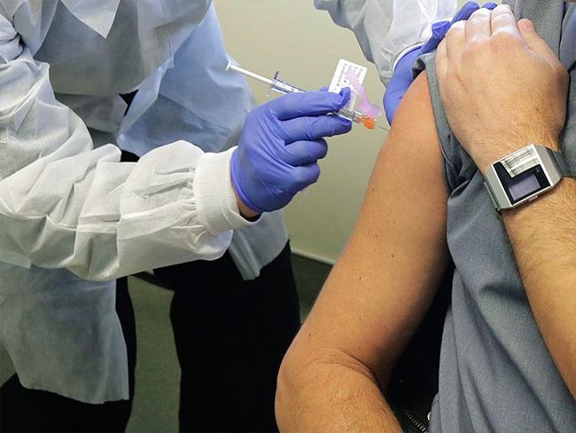 man receiving a vaccination shot