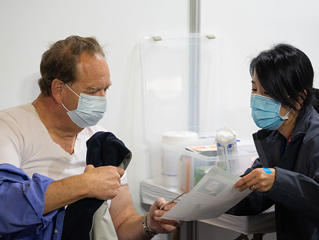 man and woman in a medical setting reviewing an informational document
