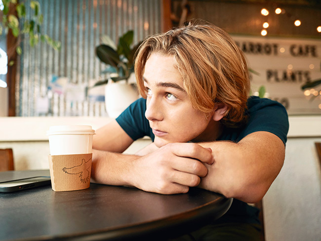 teen with coffee at cafe