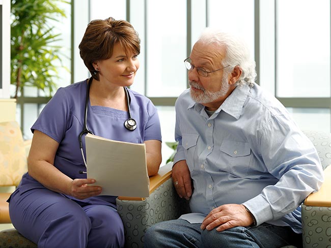 Nurse reviewing medical information with a senior man