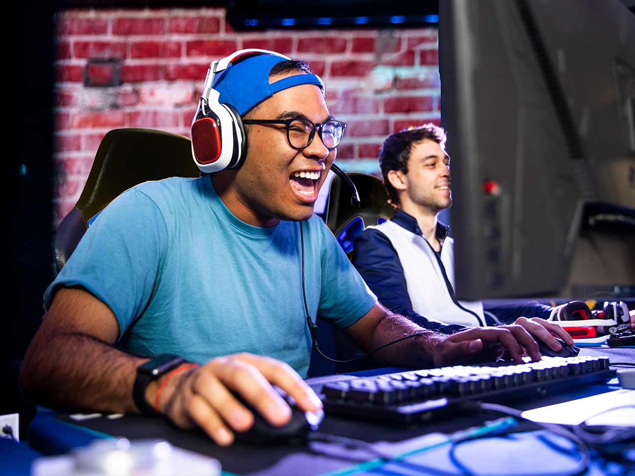 young men smiling and playing a video game