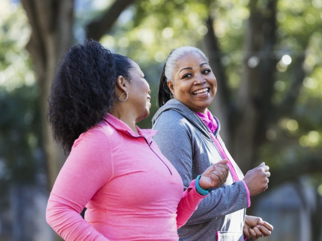 Two women walking in park