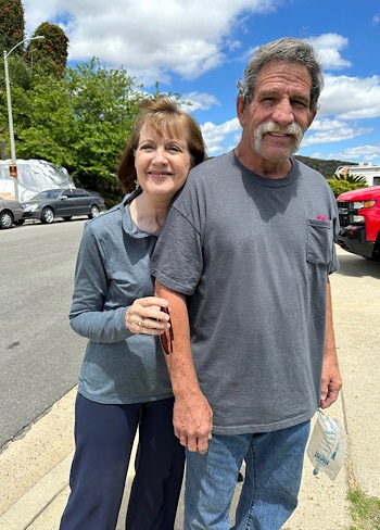 Becky Lynn hugs John Lynn as they pose for a photo together. 