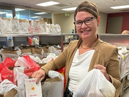 Woman packaging meals for delivery