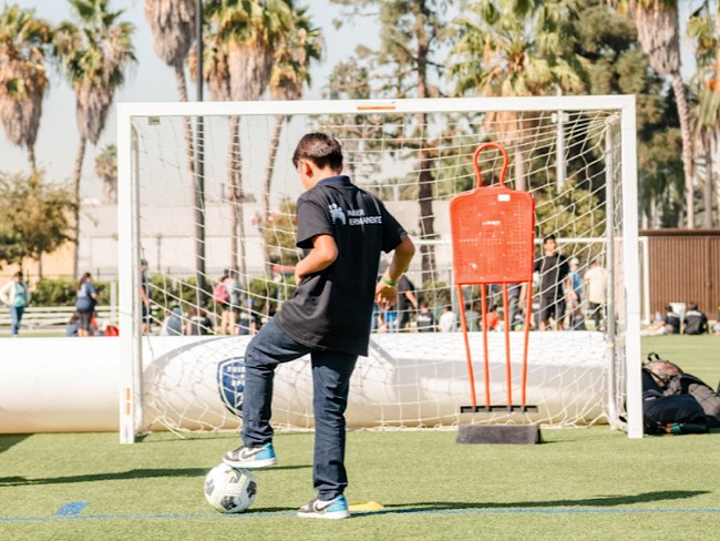 boy playing soccer outside