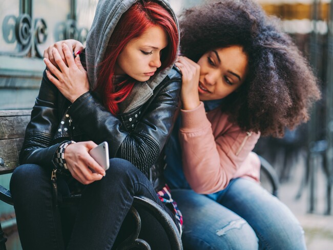 teenagers consoling each other