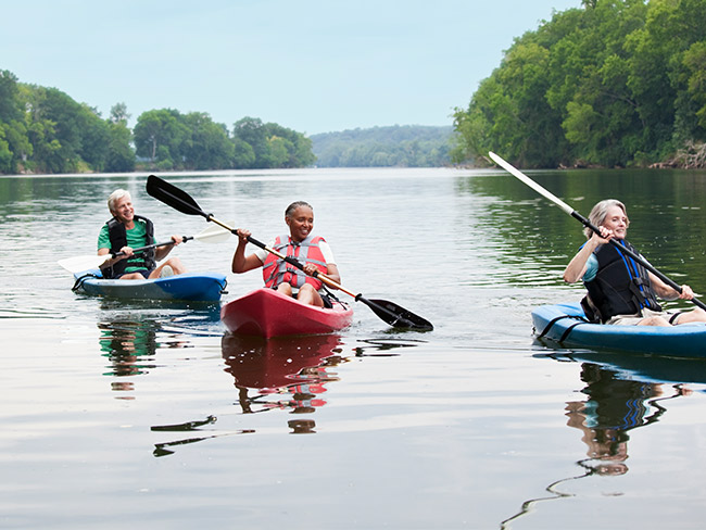 Seniors kayaking in a lake.