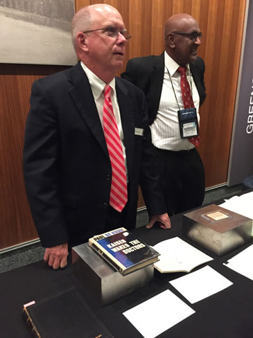 Francis J. (Jay) Crosson, MD (founding executive director of The Permanente Federation) and Richard G. Rajaratnam, MD, explain display items.v